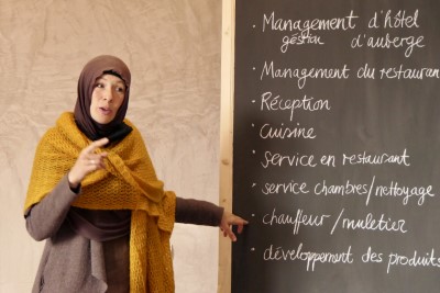 Moroccan women in front of a board